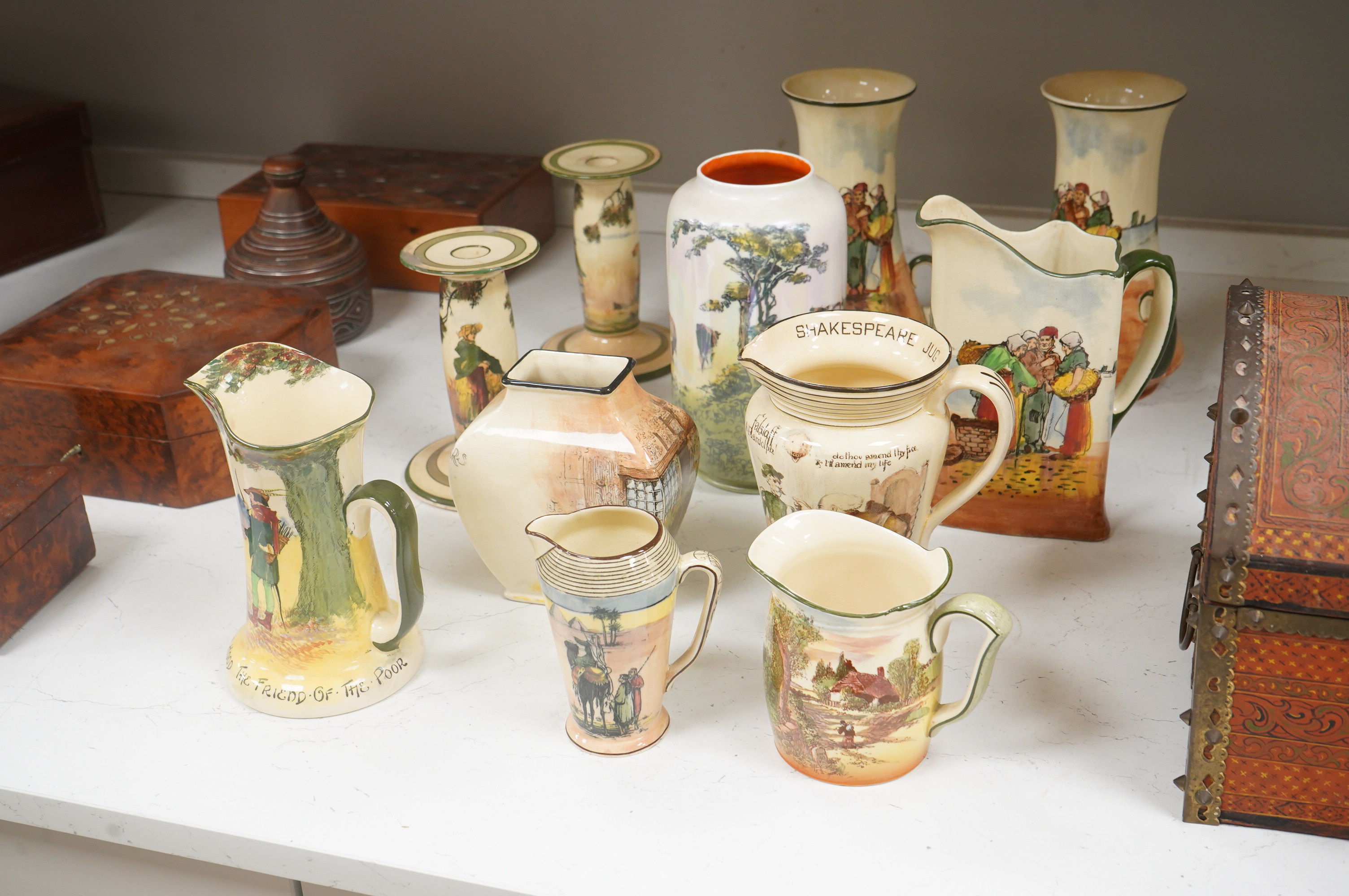 A collection of Royal Doulton series ware jugs, vases and candlesticks, largest 22cm high